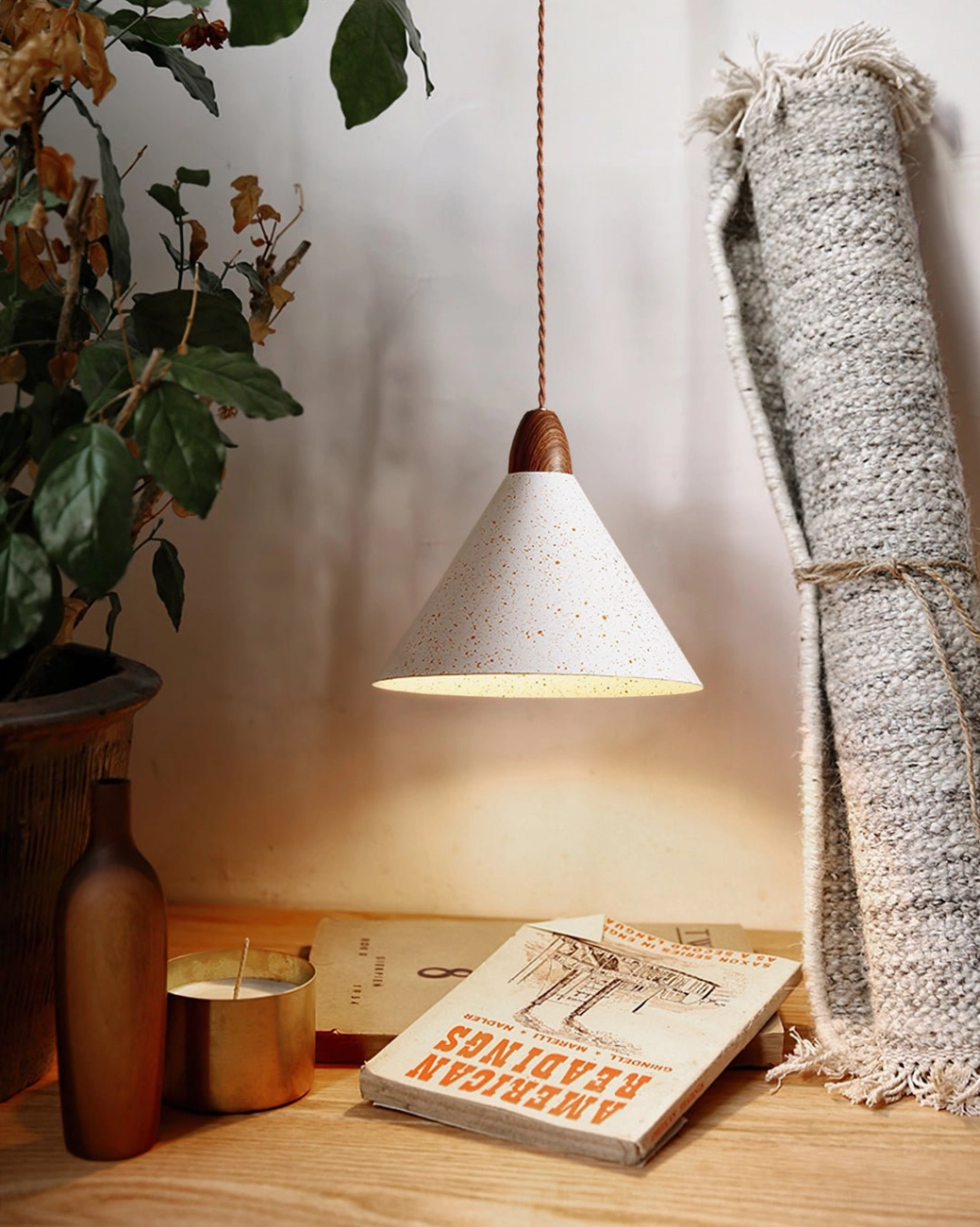 Anye conical pendant light over wooden table in cozy reading corner with bohemian rustic decor accents