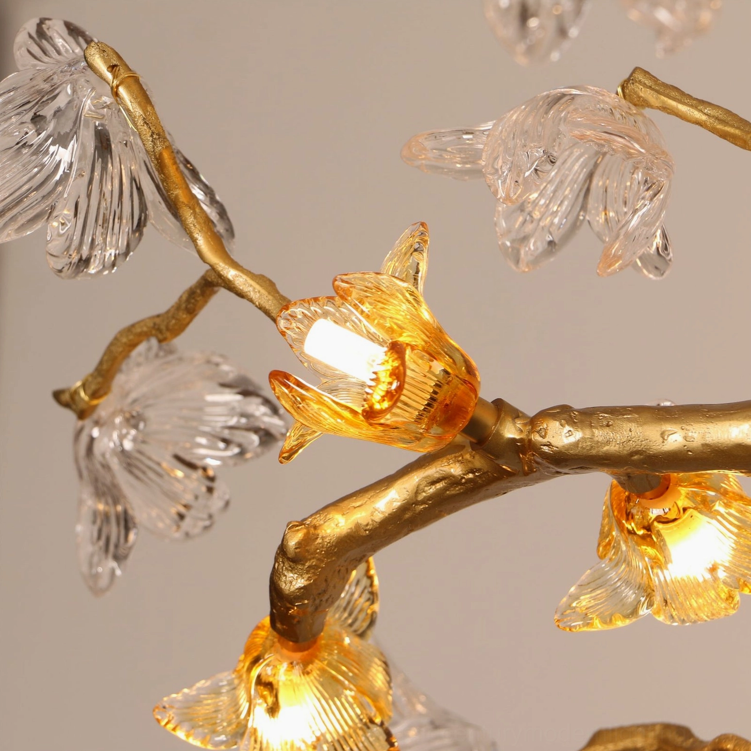 Extreme macro close-up of textured clear glass petals illuminated in Aosta Branch Chandelier shade