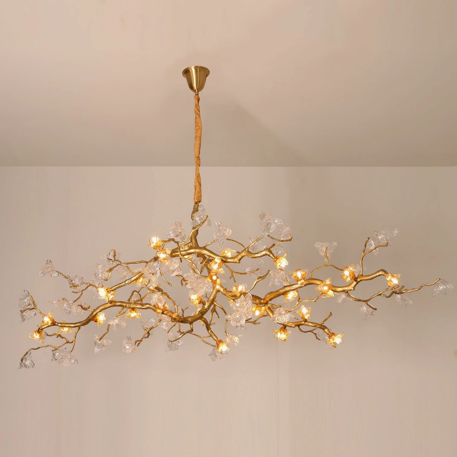 Aosta Branch Chandelier front view with glowing LED glass flower accents on minimalist white ceiling