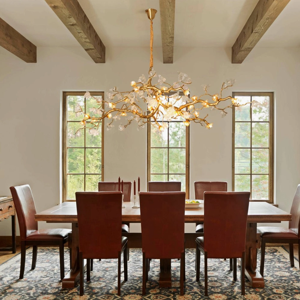 Aosta Branch Chandelier installed in rustic dining room with wooden beamed ceiling and warm candlelight glow