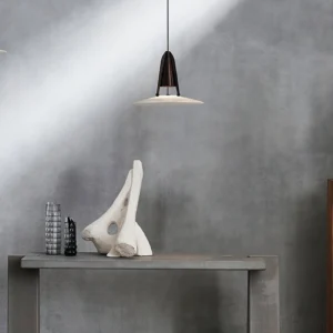 Aragon pendant light displayed on minimalist console table, upward perspective view