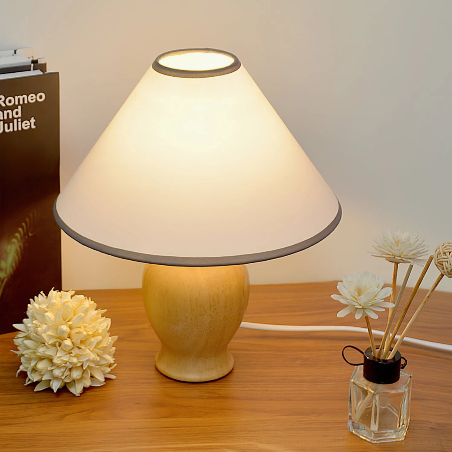 Arbol table lamp styling on home office desk with book dried flowers and floral decor, warm ambient residential lighting
