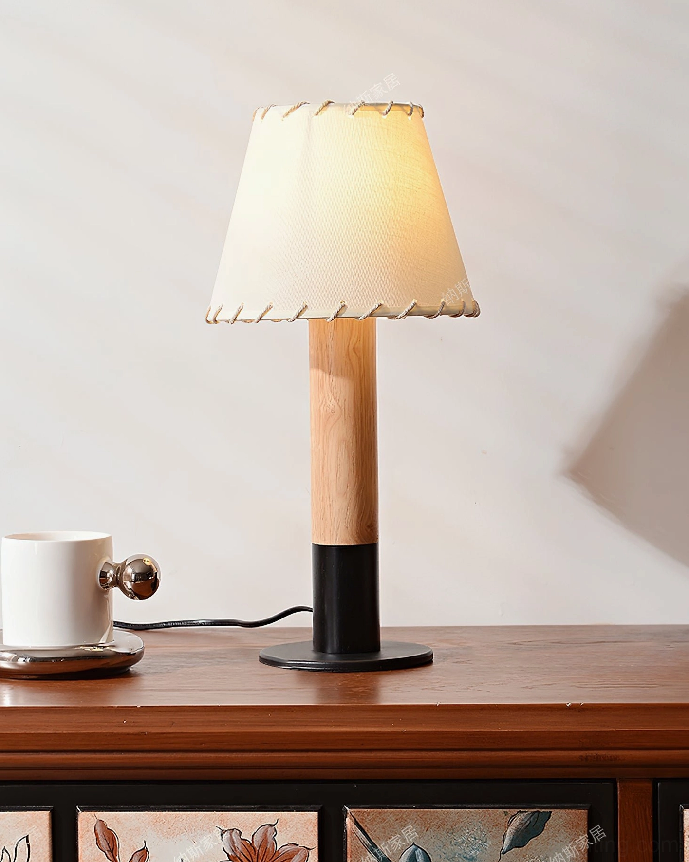 Arbor table lamp styled on wooden console with coffee mug and warm ambient lighting
