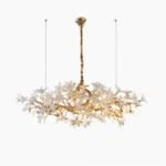 Arboris Blossom Branch hand-forged brass chandelier front view with white floral ornaments and gold branches