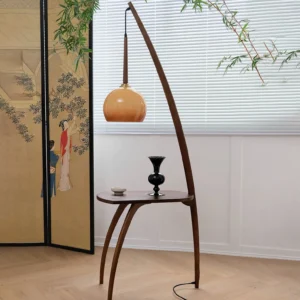 Mid-century modern arc floor lamp with integrated side table, three-quarter view showing curved wooden frame and amber glass