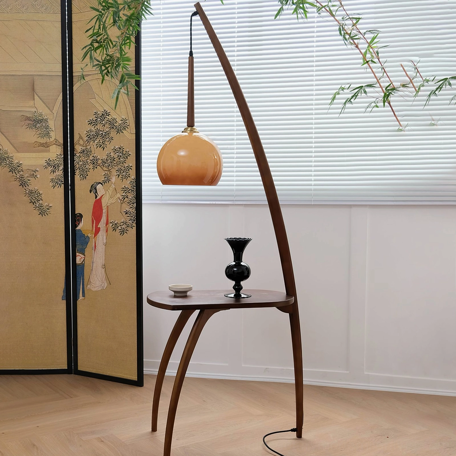 Mid-century modern arc floor lamp with integrated side table, three-quarter view showing curved wooden frame and amber glass