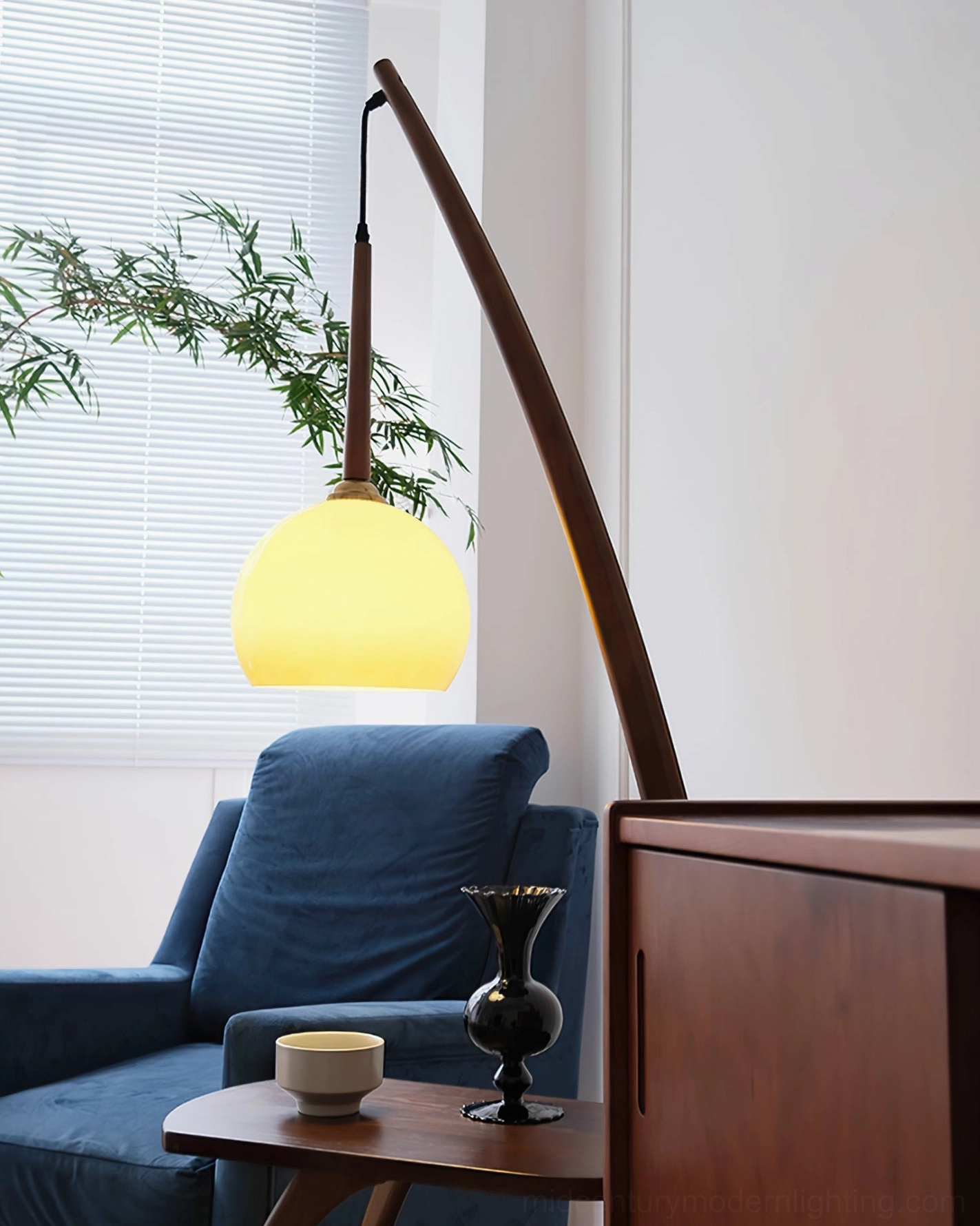 Domus Pollo arc lamp with side table, warm interior styling, ambient home setting