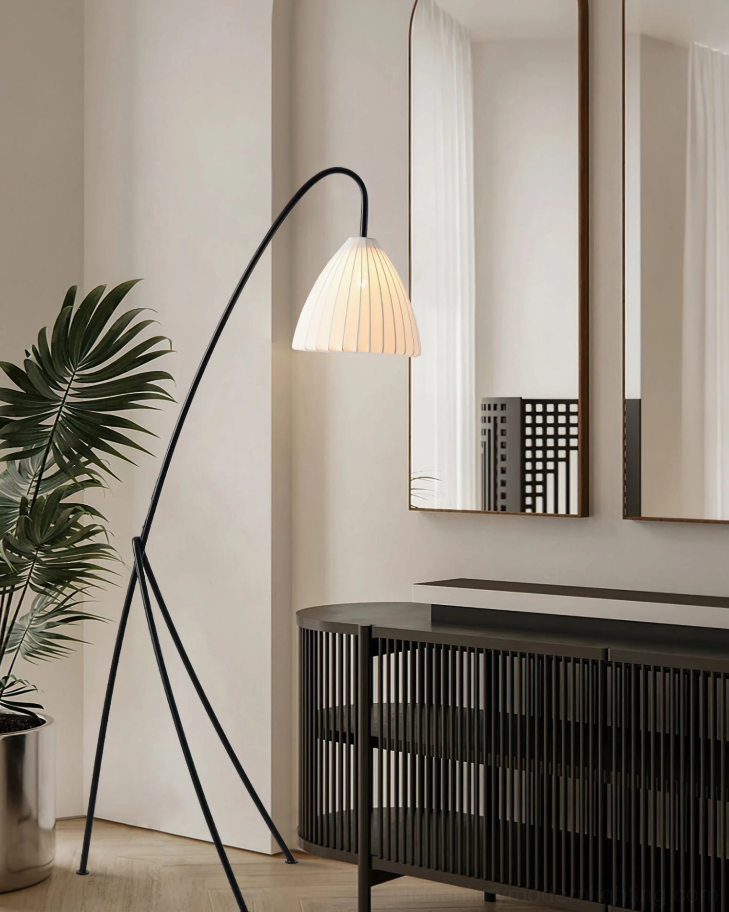 Curved arc floor lamp in modern hallway with console furniture, warm minimalist home interior styling with eye-level perspective
