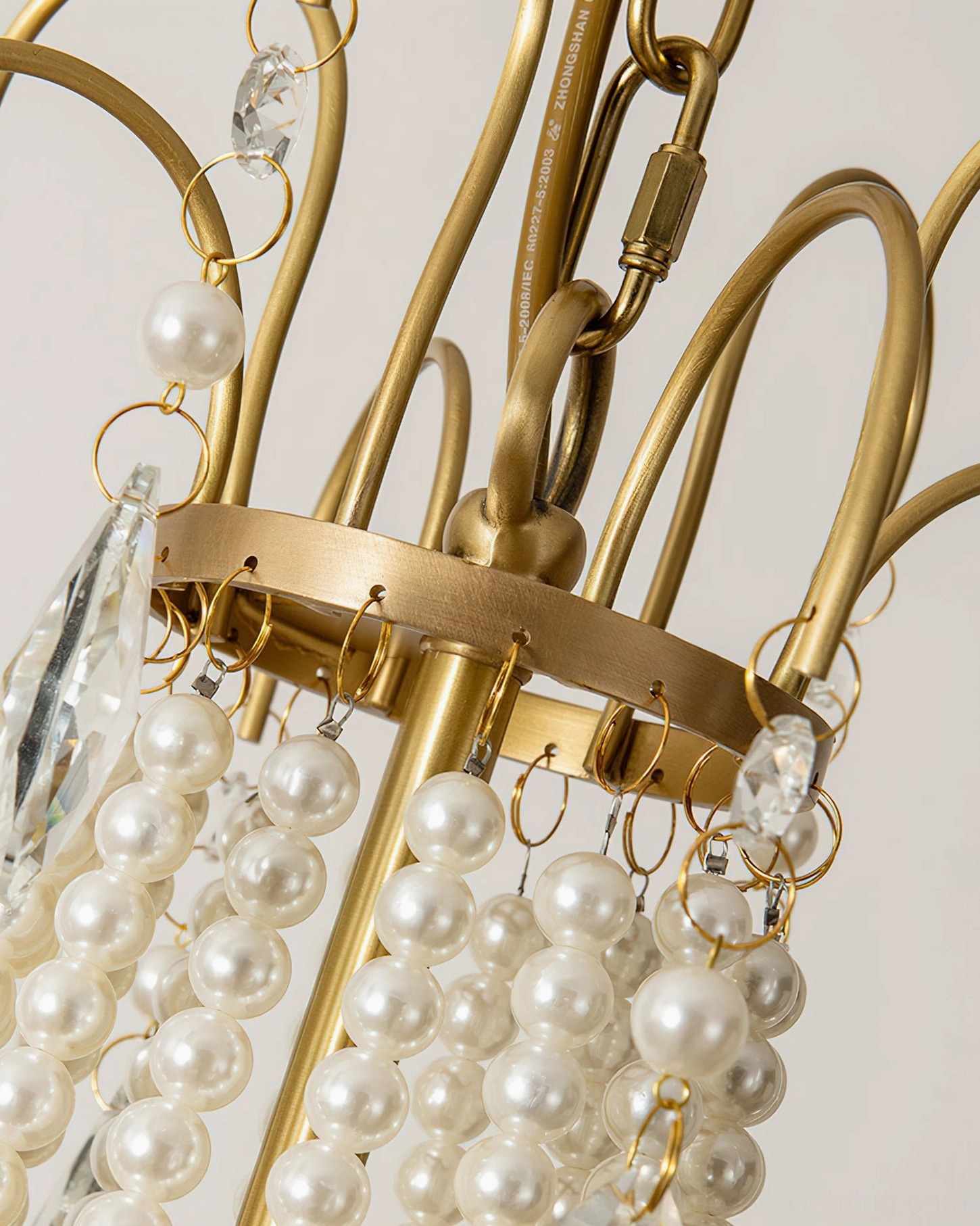 Arcadia chandelier brass gold joints and hardware with crystal and pearl decoration detail view
