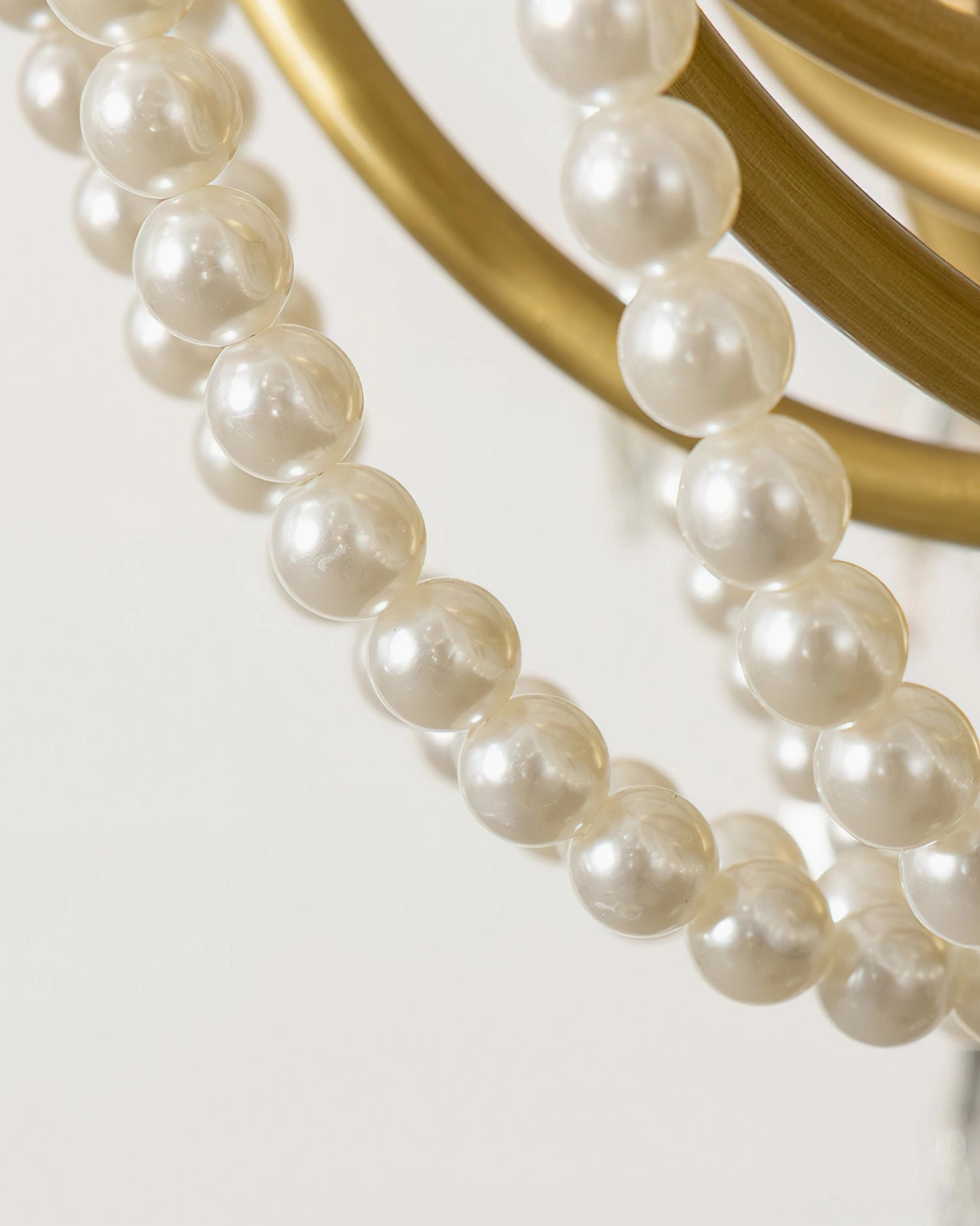 Close-up detail of Arcadia chandelier pearl beads and crystal drops showing craftsmanship and luxurious materials