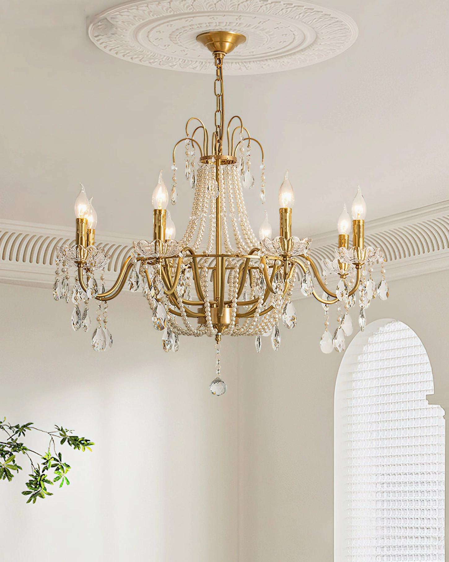Arcadia gold chandelier in French vintage home setting with arched window and indoor plants, classic elegance
