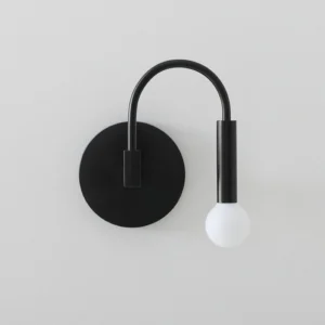 Arch wall lamp close-up detail shot showing frosted glass sphere and metal arm construction