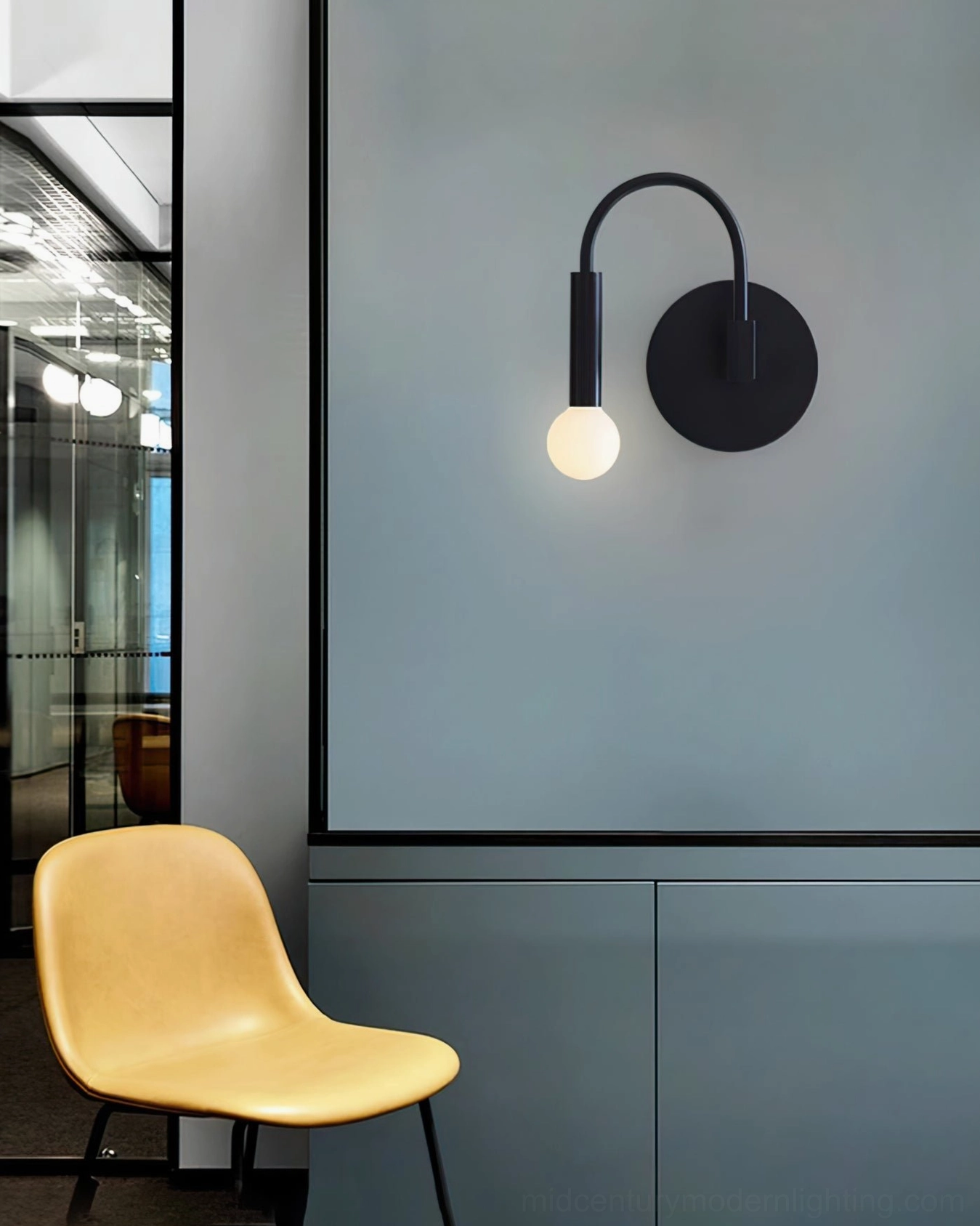 Arch wall lamp in modern hallway space with contemporary furniture and yellow accent chair
