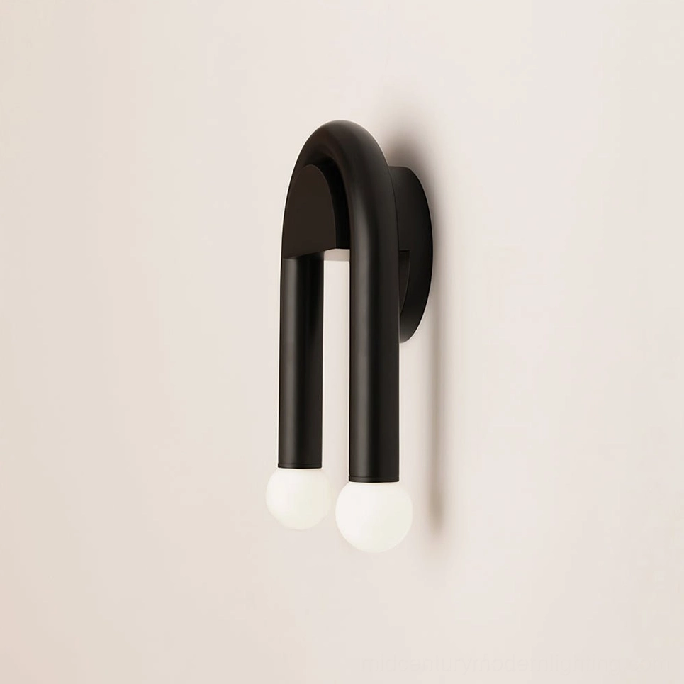 Double arched wall lamp close-up side view showcasing matte black curved arms and clear glass globes