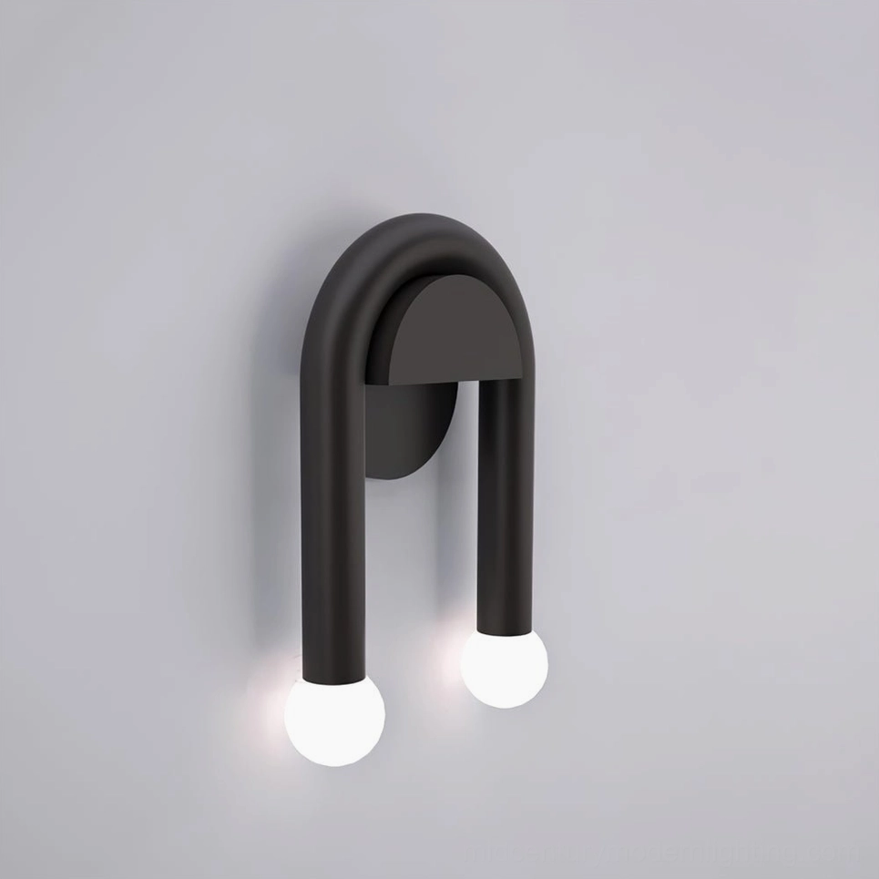 Black arched wall sconce three-quarter side perspective showing curved metal frame and dual LED globe lights