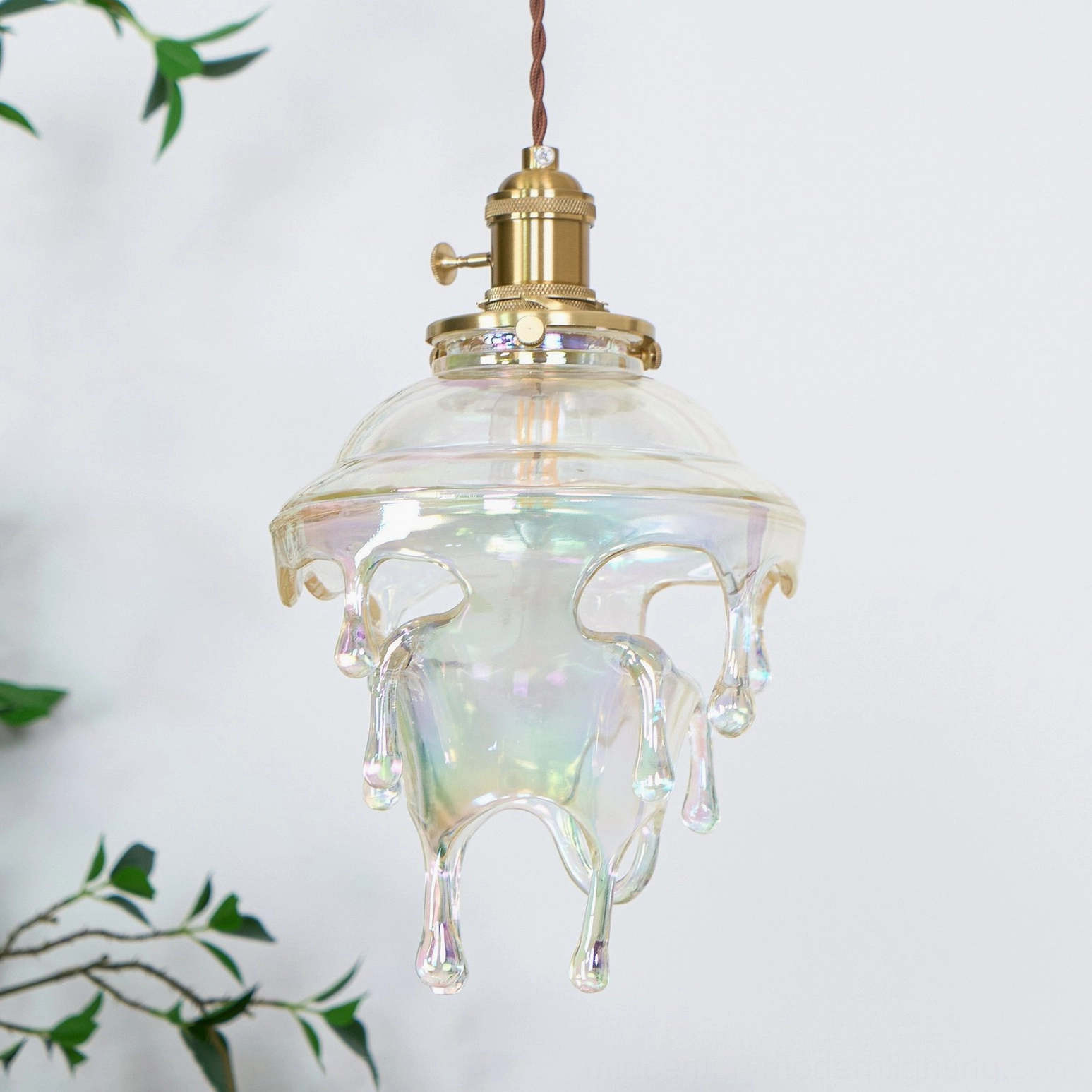 Architectural detail of brass crown and E14 socket base on water droplets resin pendant