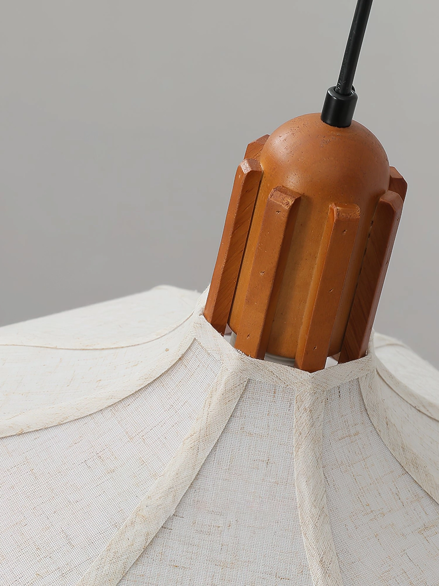 Top view of Arden pendant showing grooved walnut wood ceiling cap and shade connection