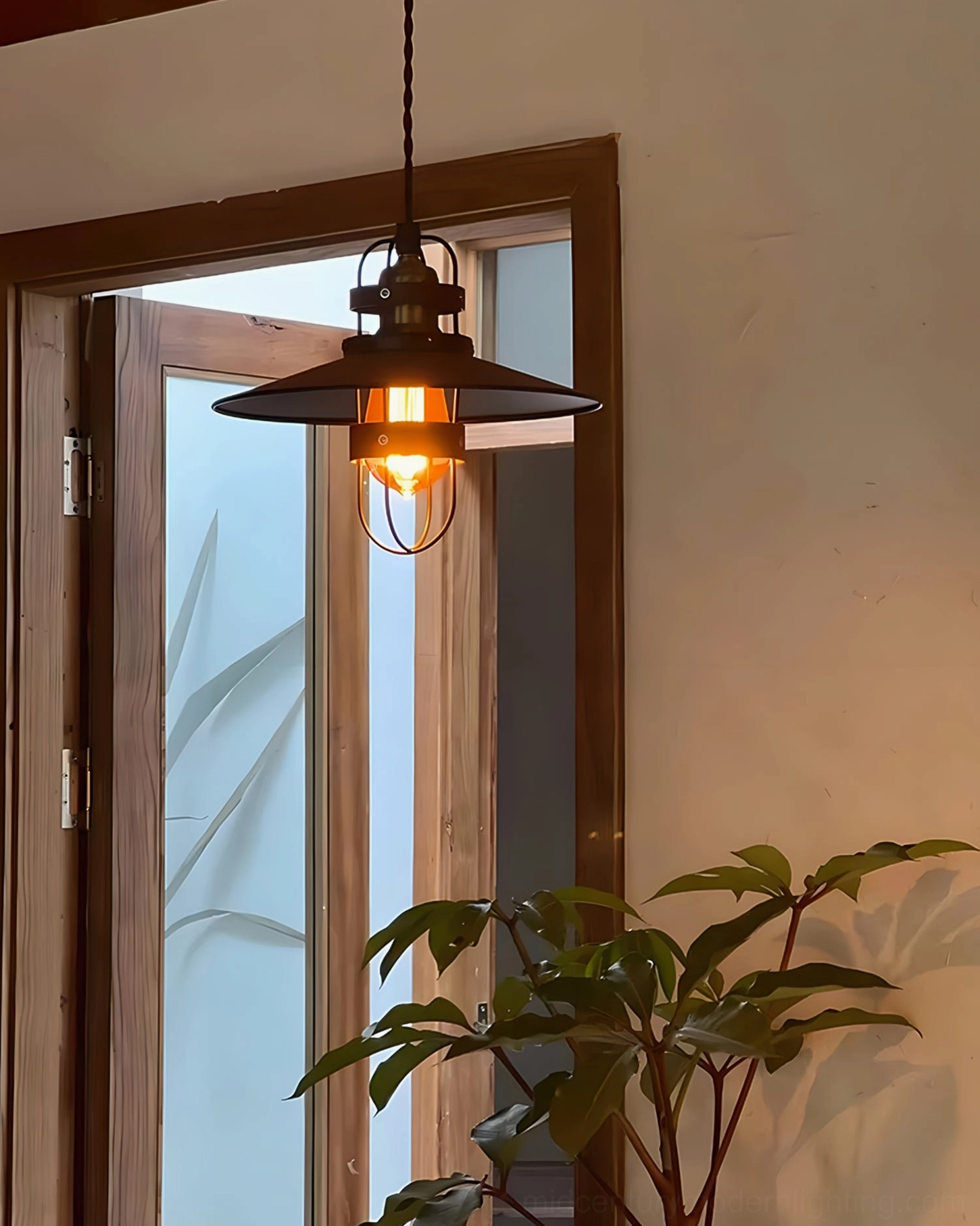 Arely pendant lamp hanging in warm entryway with potted plant, showcasing soft ambient lighting through metal cage