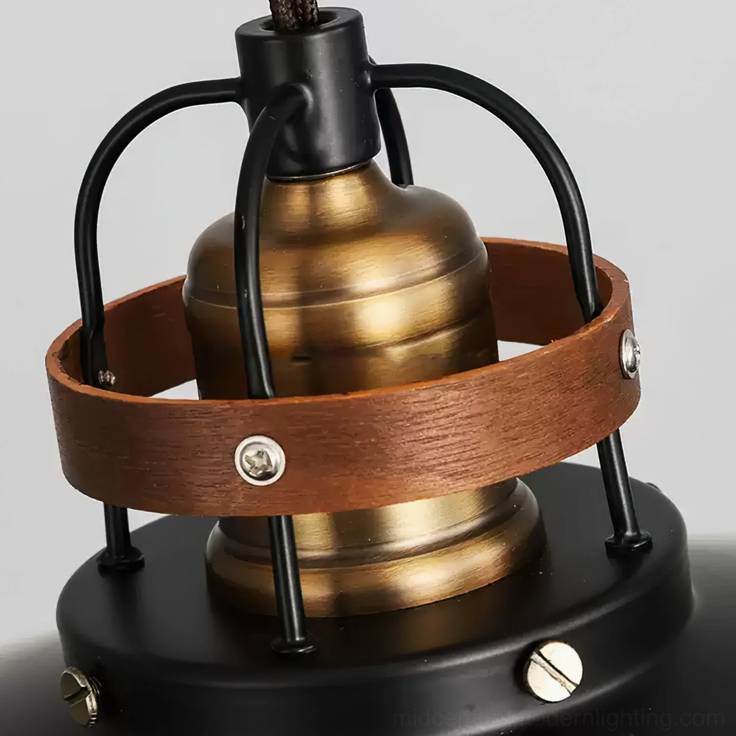 Top view detail of Arely pendant lamp showing brass-toned metal body, brown walnut wood strap, and black metal frame construction