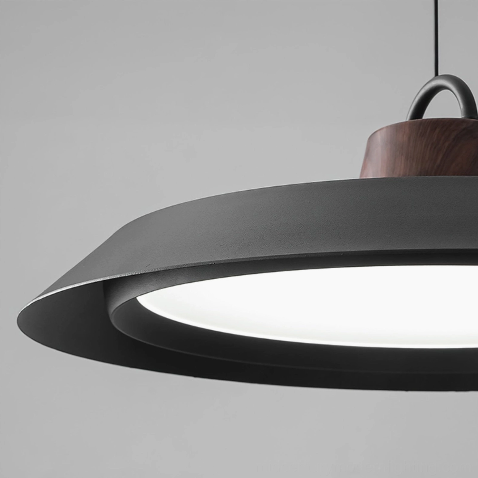 Side profile of Arenal black disc pendant lamp, showing slim minimalist silhouette