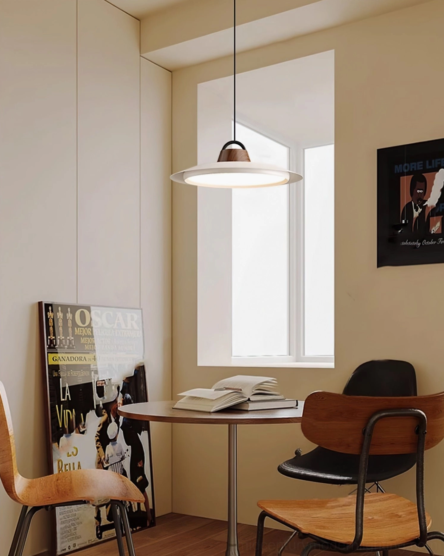 Arenal disc pendant light installed over modern dining table in residential interior
