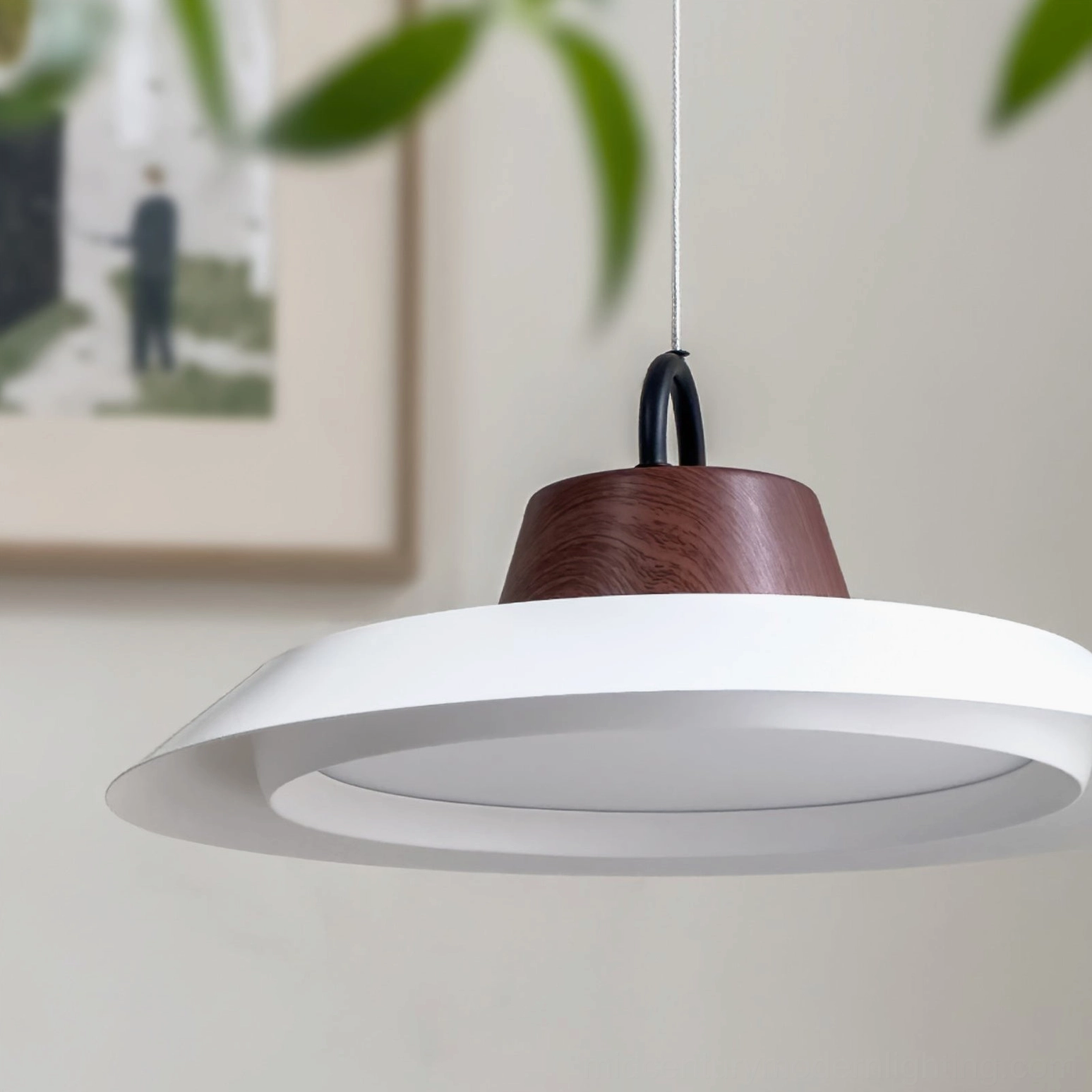Arenal disc pendant installed above framed wall art, demonstrating mid-century modern interior styling