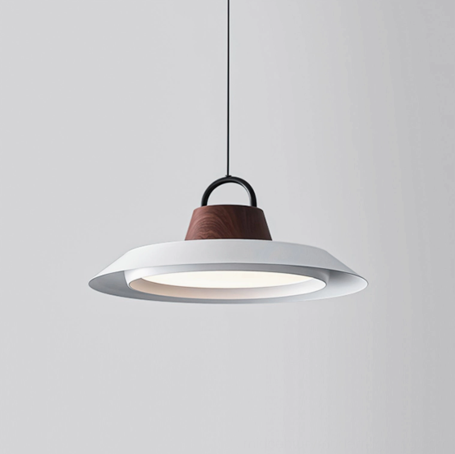 Close-up detail of Arenal disc pendant showing matte white finish and premium acrylic diffuser construction