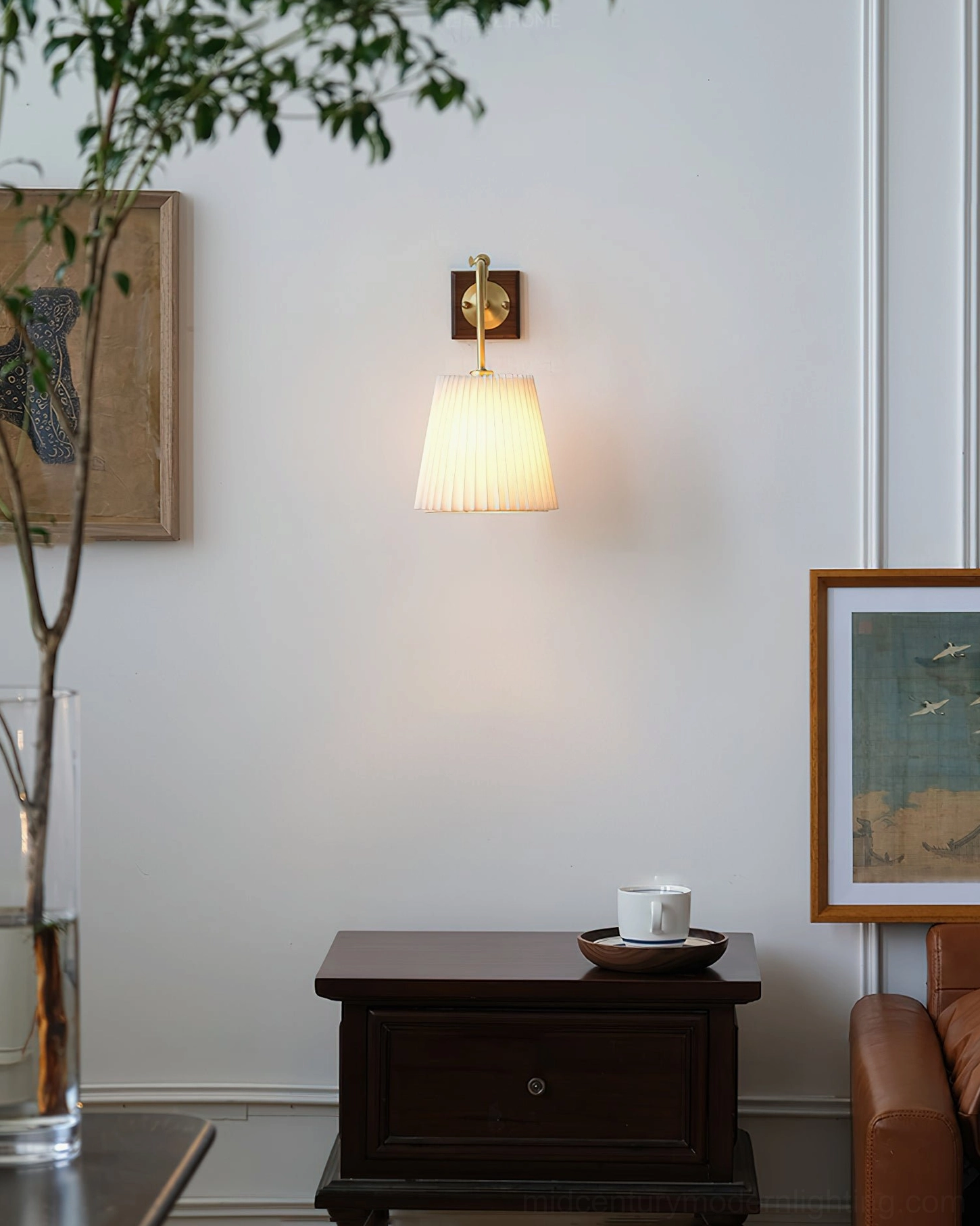 Argon fabric wall lamp glowing in cozy Nordic living room interior with framed artworks and decorative accessories