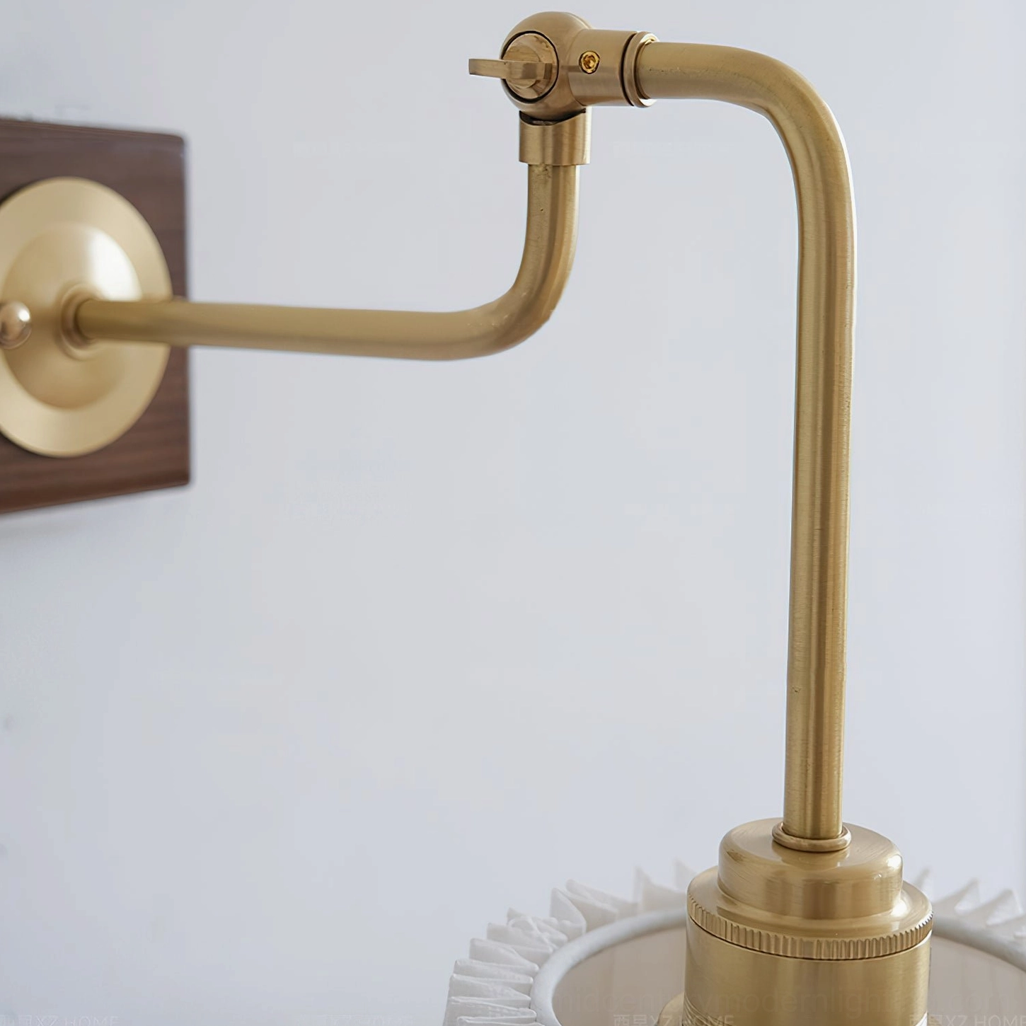 Argon wall lamp hardware components featuring brass curved arm, walnut wood wall mount, and adjustable articulating joint