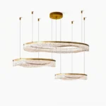 Aria three-tier modern ring chandelier with brass accents and textured resin shades overhead view