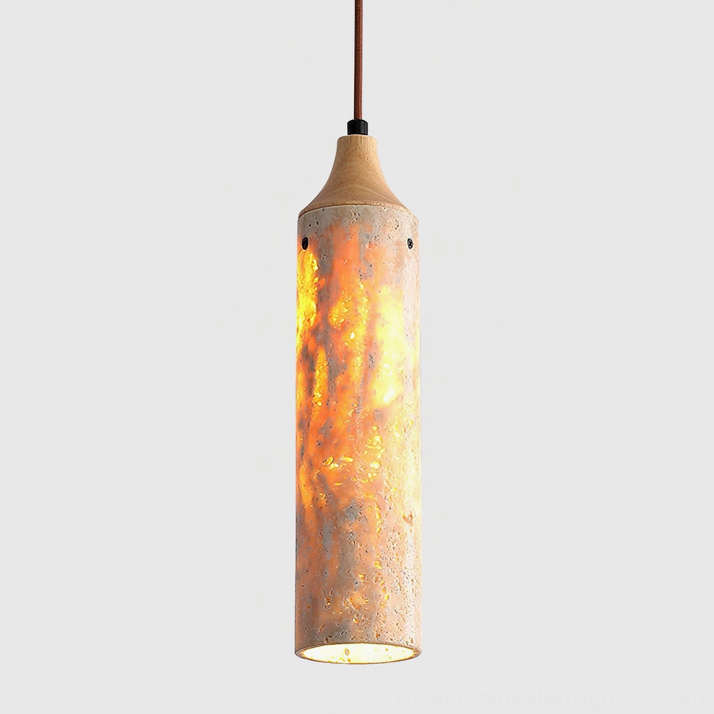 Arlene pendant lamp positioned above dining table with natural stone shade casting diffused light
