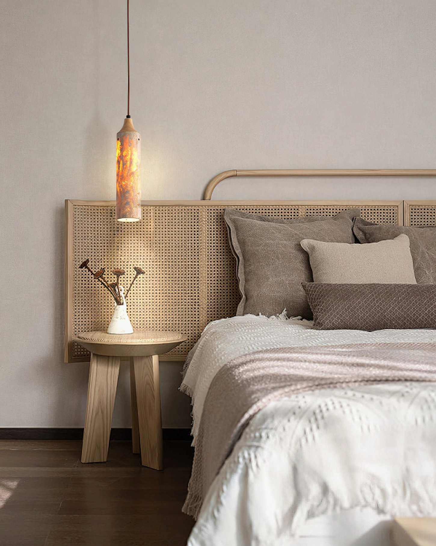 Textured travertine Arlene pendant lamp in minimalist master bedroom with layered neutral bedding