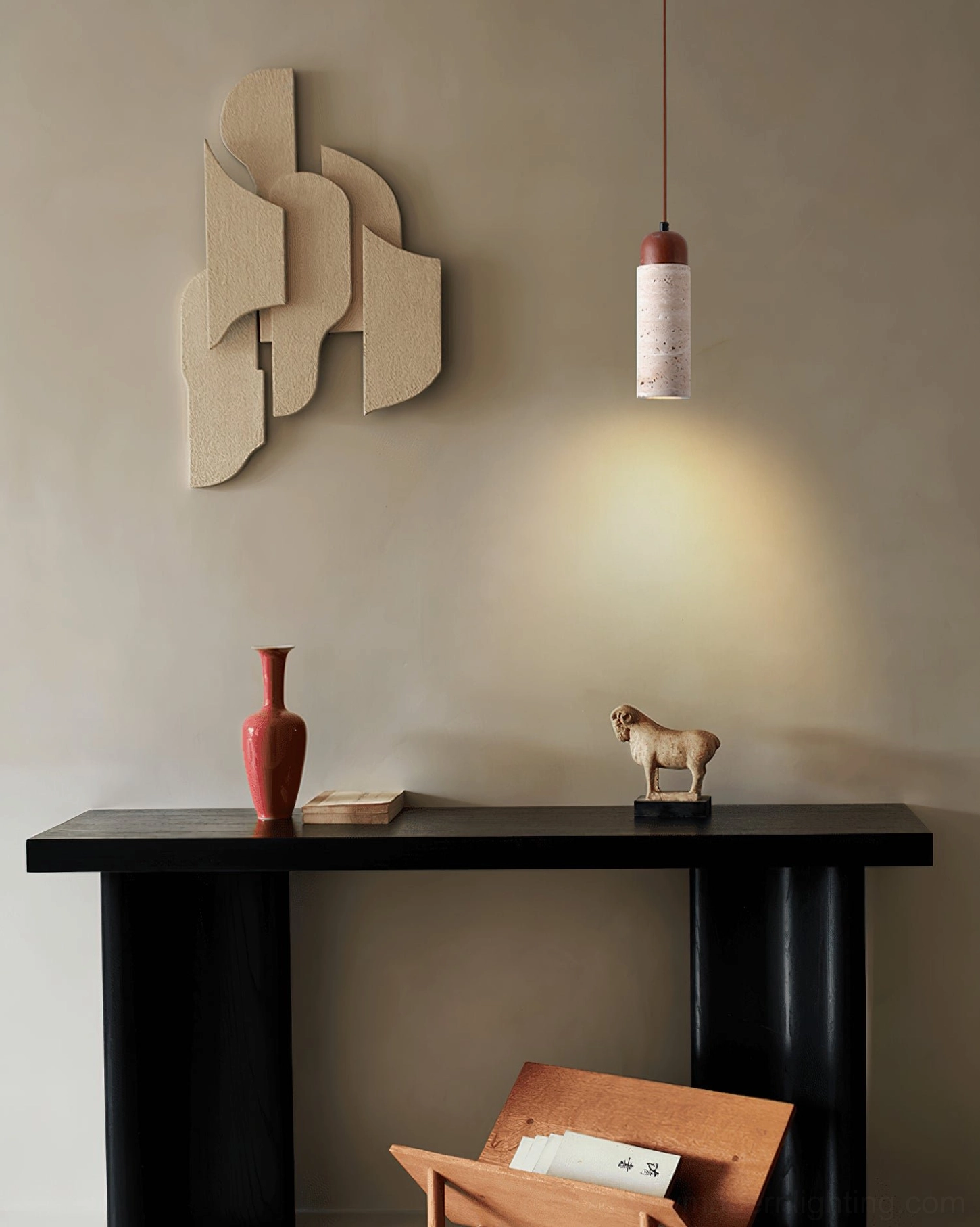 Arlene travertine and wood pendant mounted on wall above console table with abstract art