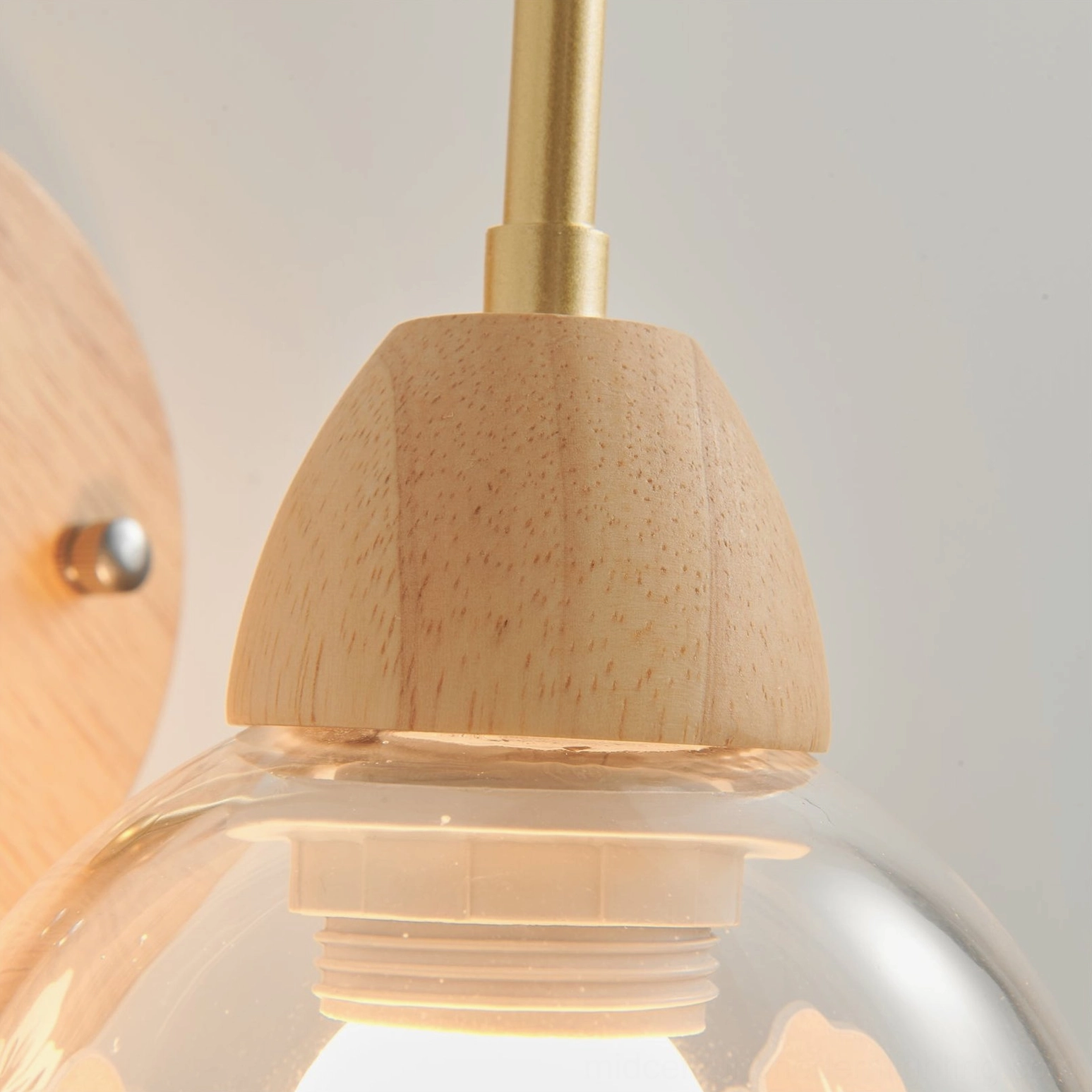 Overhead view of wooden wall lamp components showing solid wood base and brass metal construction