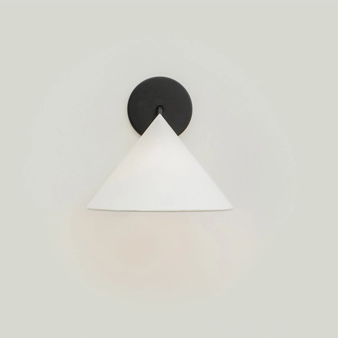 Arno wall sconce in warm brass finish with conical fabric shade, profile view on neutral background
