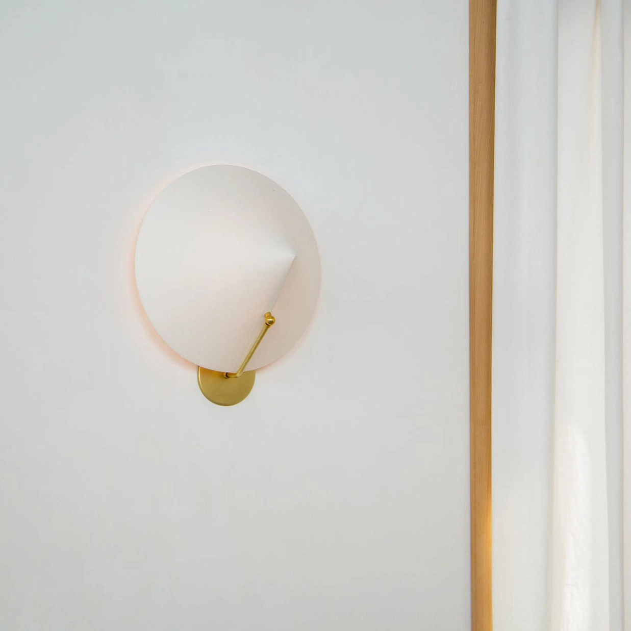 Arno wall sconce in aged bronze finish with white conical shade, elegant lighting fixture detail