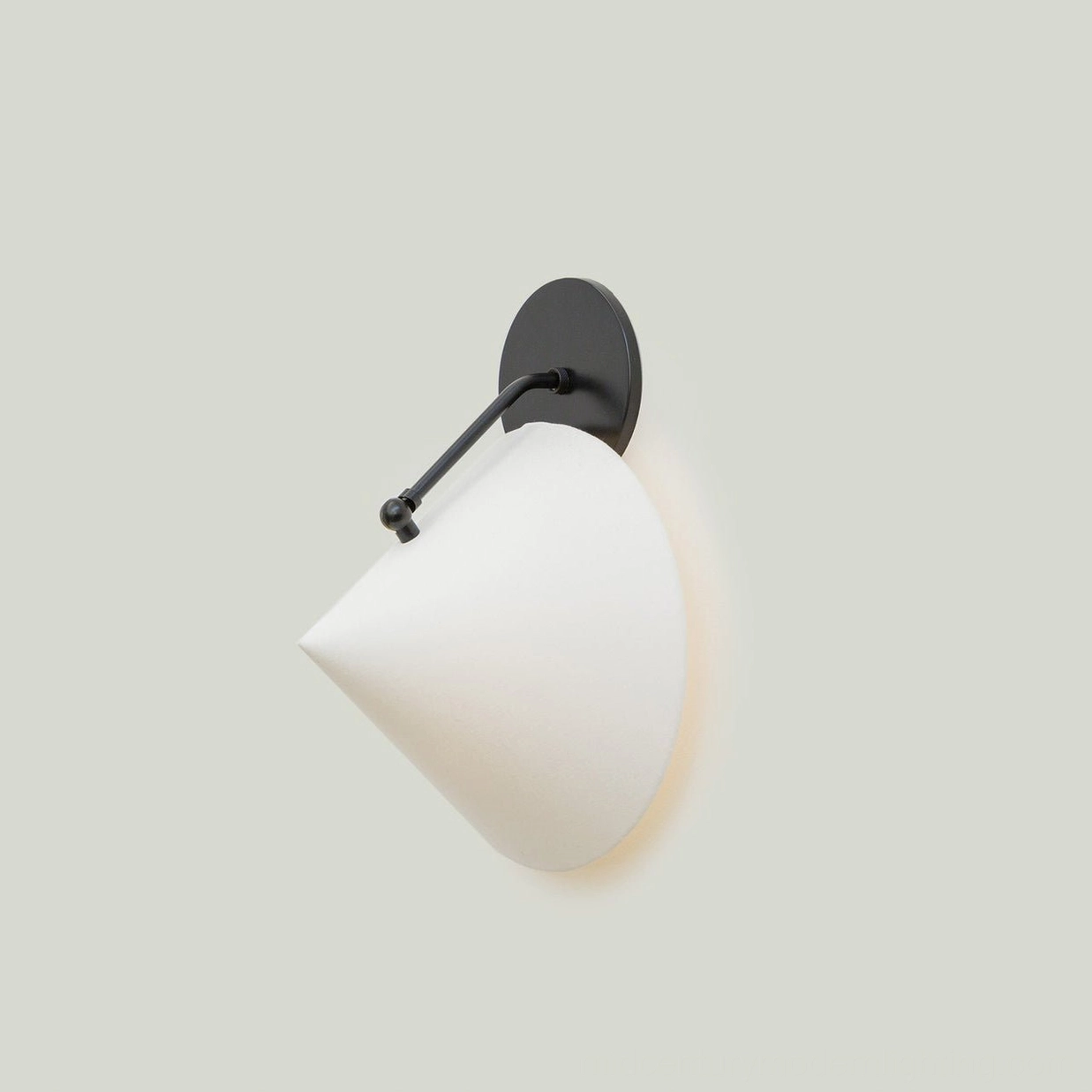 Arno wall sconce in white finish with brass hardware, contemporary minimalist living space
