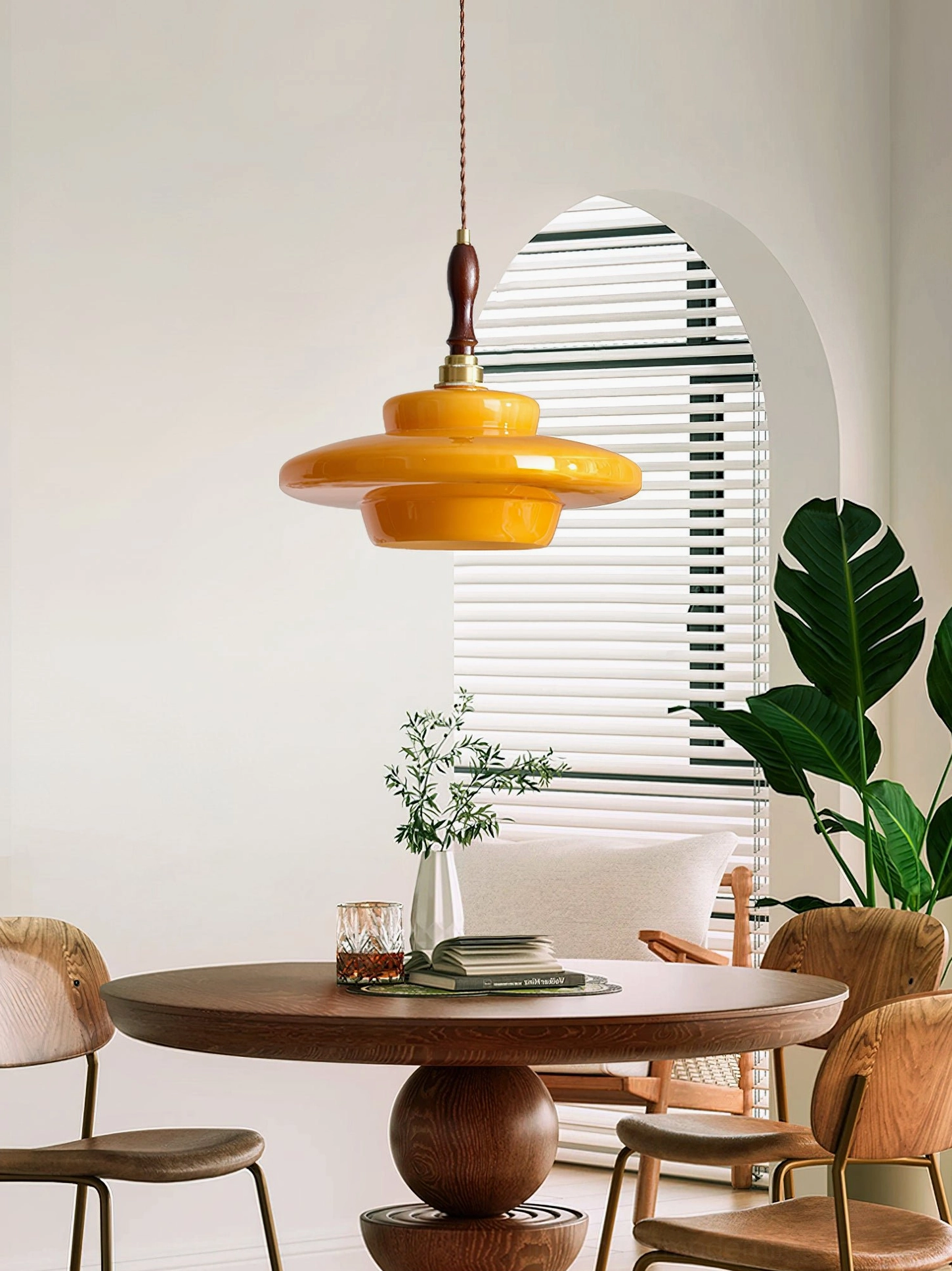 Aroma mid-century pendant lamp hanging in vintage dining room with arched window and warm ambiance