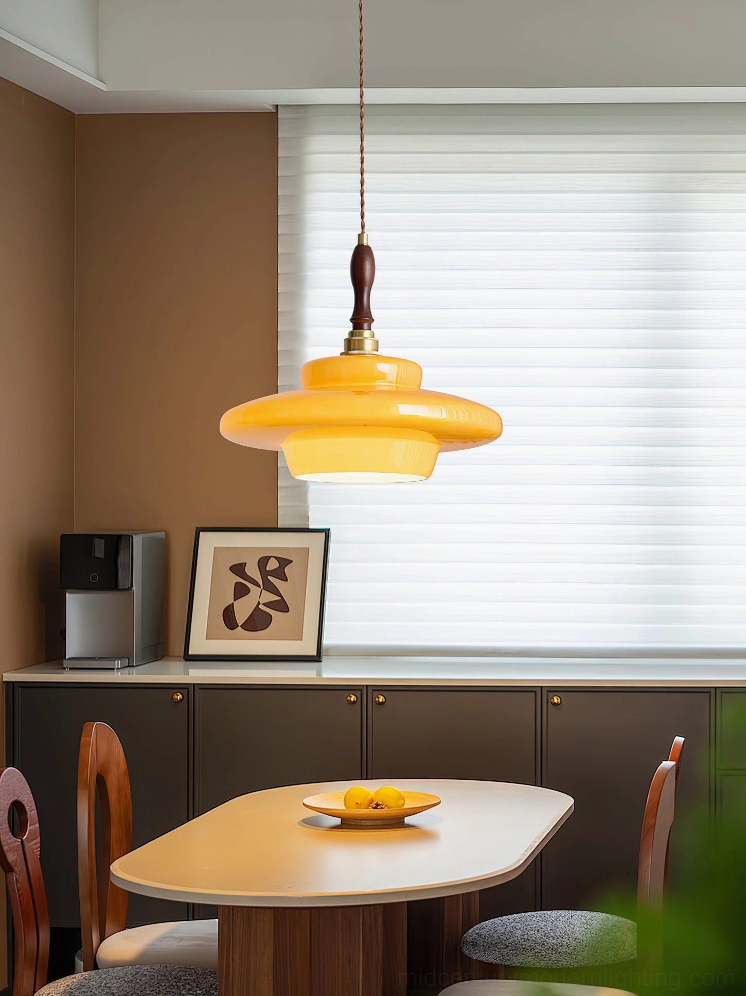 Aroma pendant light in modern kitchen dining space with dark cabinetry and wooden furniture decor