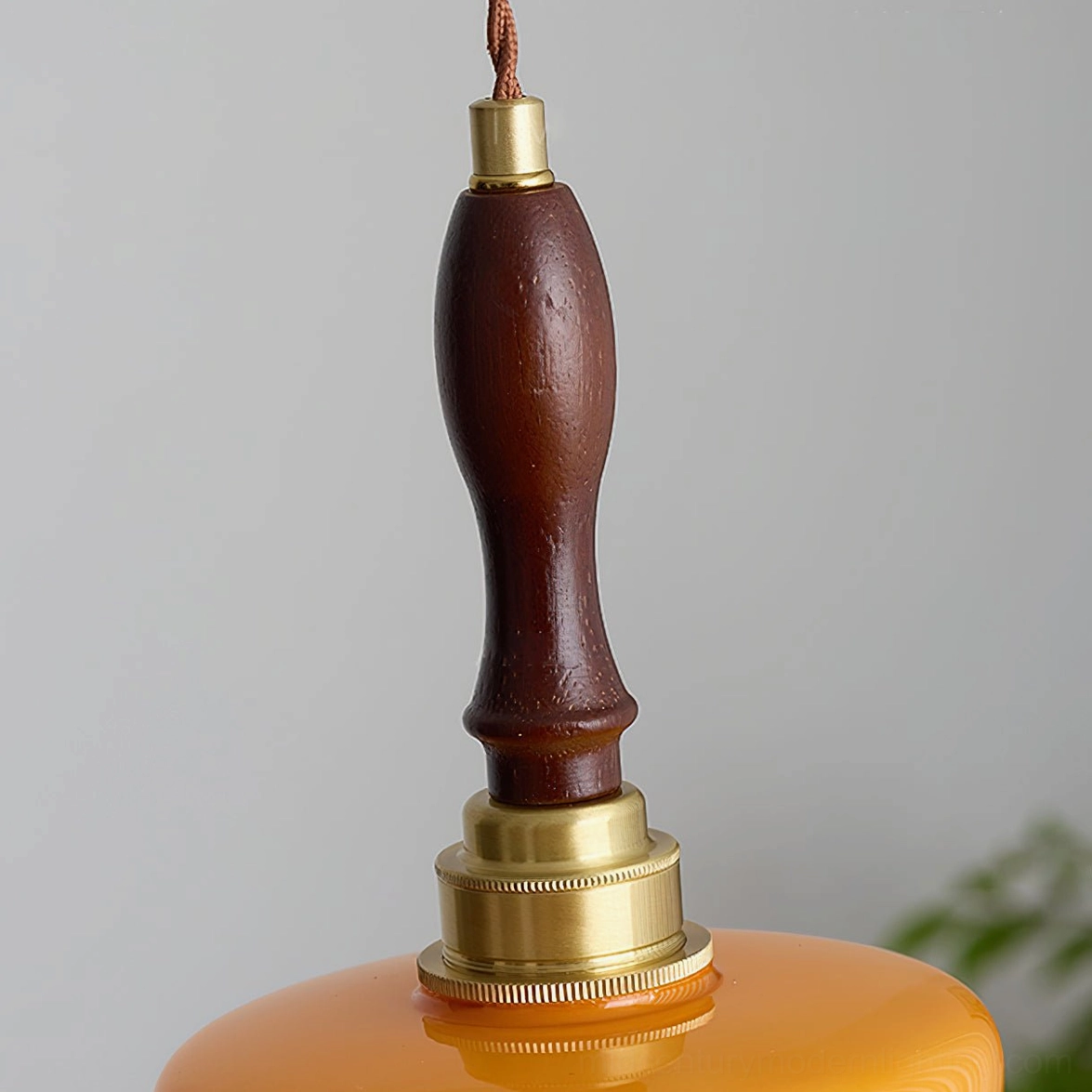 Detailed overhead view of Aroma pendant lamp hardware featuring solid walnut wood and polished brass components