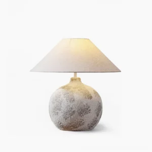 Arosa ceramic table lamp with textured white base and tapered linen shade - studio front view