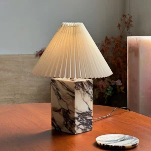 Arouca marble table lamp displayed on warm dining table with marble coaster and ambient lighting