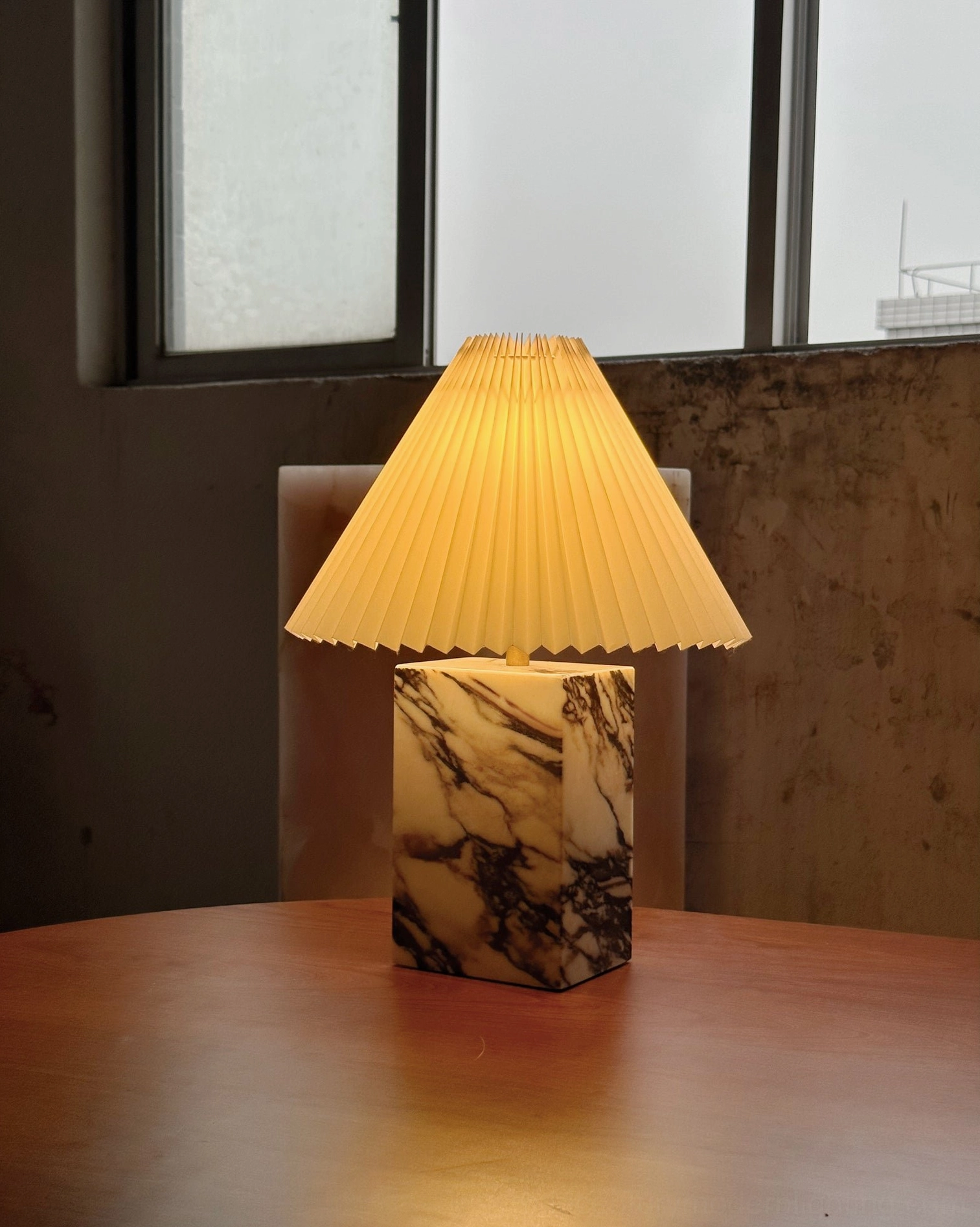 Arouca marble table lamp with off-white pleated shade and veined natural stone base