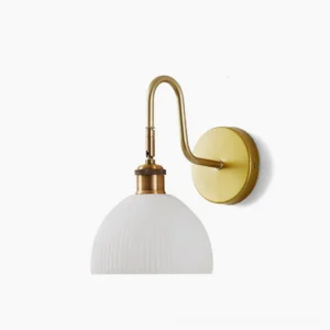 Arren brass wall sconce with curved arm and ribbed glass dome on white background, mid-century modern design