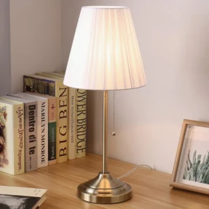 Arstid mid-century modern table lamp styled on home office desk with books and photo frame