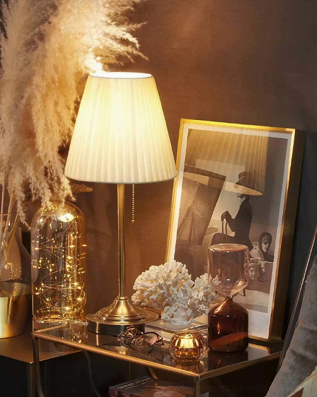 Modern Arstid table lamp with brass pole on contemporary bedroom nightstand against blue accent wall