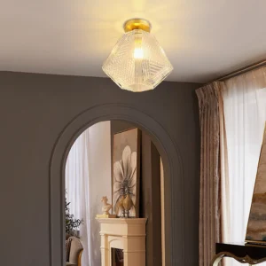 Brass Art Deco ceiling pendant installed in modern luxury home entryway with arched doorway
