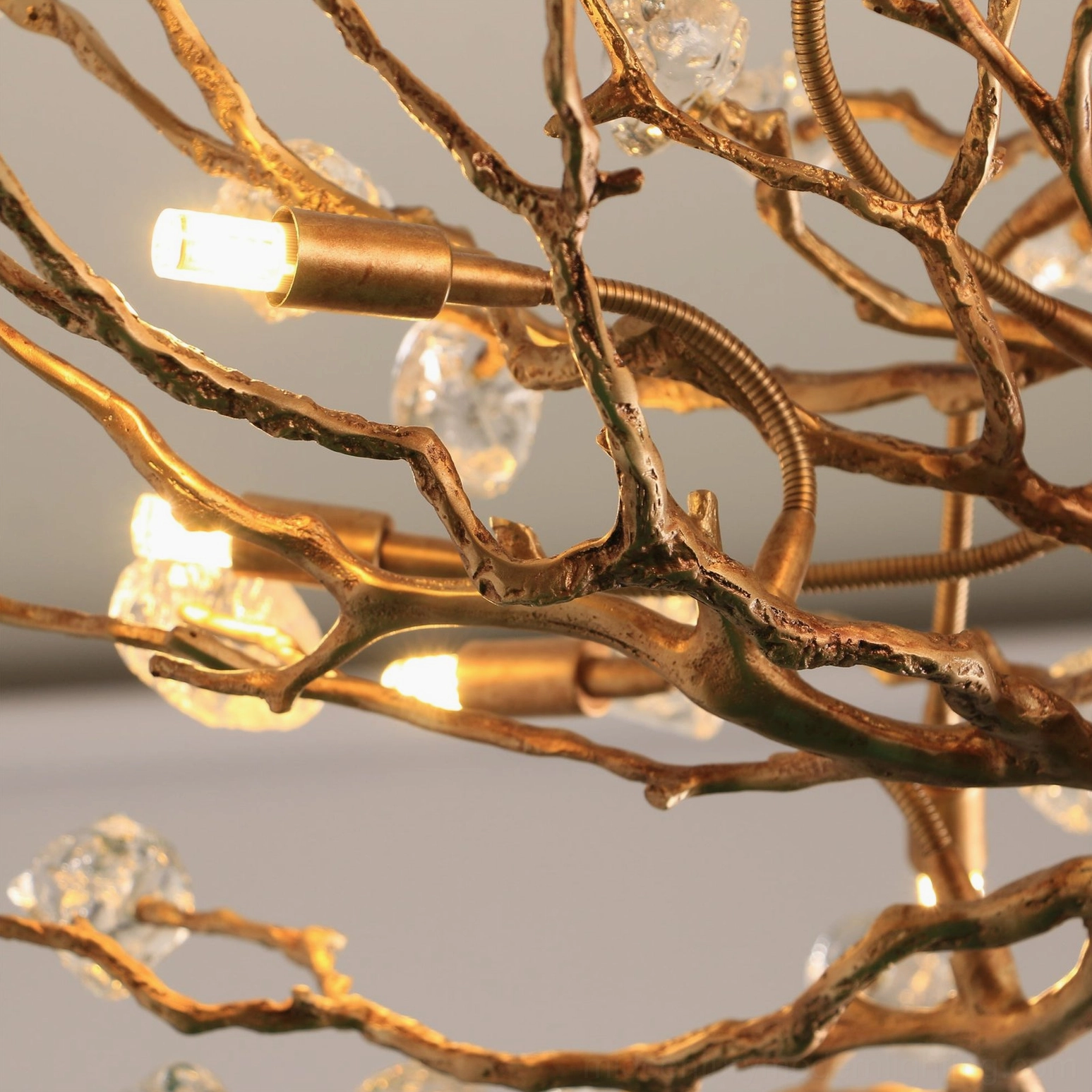 Warm white studio background showcasing art deco gemstone branch chandelier design details