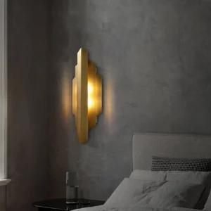 Art Deco wall sconce mounted on dark concrete wall in modern minimalist bedroom with grey bedding