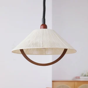 Arta mid-century modern pendant light three-quarter view showing pleated hemp shade and walnut accent